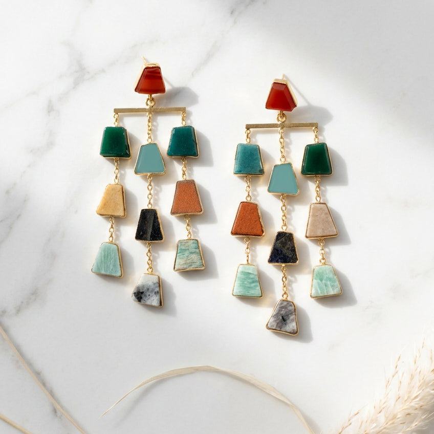 A pair of gold-tone dangle earrings with multiple small geometric stone charms in green, 